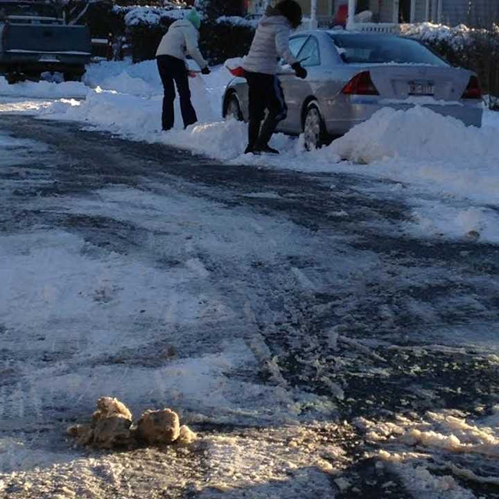 Jordan Levy and her mother Elaine shoveling out their car on Saturday.