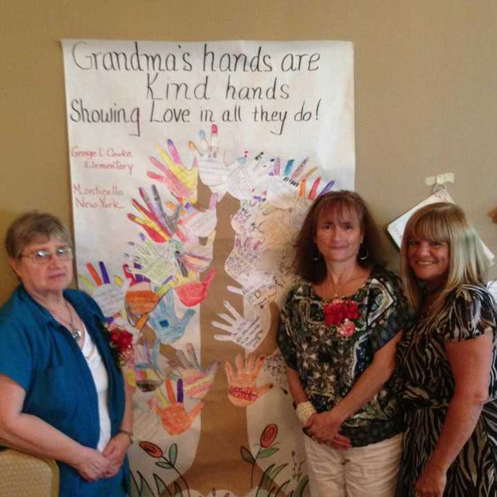 &quot;Grandma Emelie,&quot; &quot;Grandma Maureen,&quot; and Assistant Principal Rosemarie Romano standing with a project made by their students.