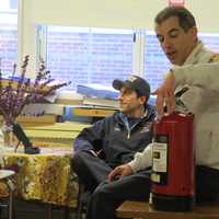 <p>Eastchester Fire Capt. Thomas Pintaville demonstrating the proper utilization of a fire extinguisher.</p>