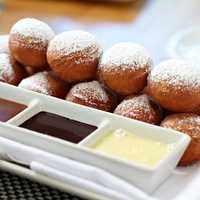 <p>Moderne Barn&#x27;s Petits Beignets: fried doughnut holes, strawberry preserves, caramel sauce &amp; dark chocolate sauce</p>