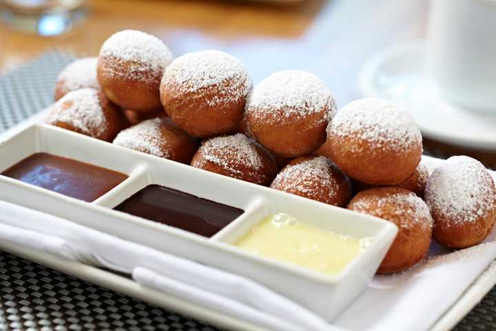 Moderne Barn&#x27;s Petits Beignets: fried doughnut holes, strawberry preserves, caramel sauce &amp; dark chocolate sauce