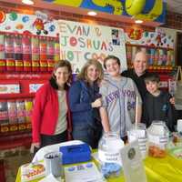 <p>Nancy Joselson and the Greenberg family at their hot cocoa stand in Scarsdale.</p>