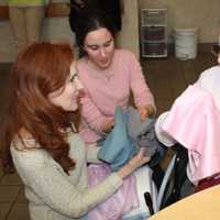 <p>A Waveny LifeCare Network receives a scarf from Caren &amp; Forbes.</p>