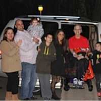 <p>Vince Yackery sits in a van surrounded by his family. The van was purchased with support from the Darien community.</p>