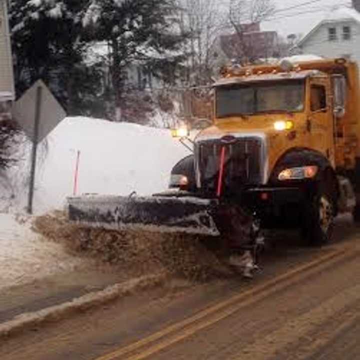 The roads in Danbury look covered in as much sand as snow as a city plow clears during the nor&#x27;easter. 