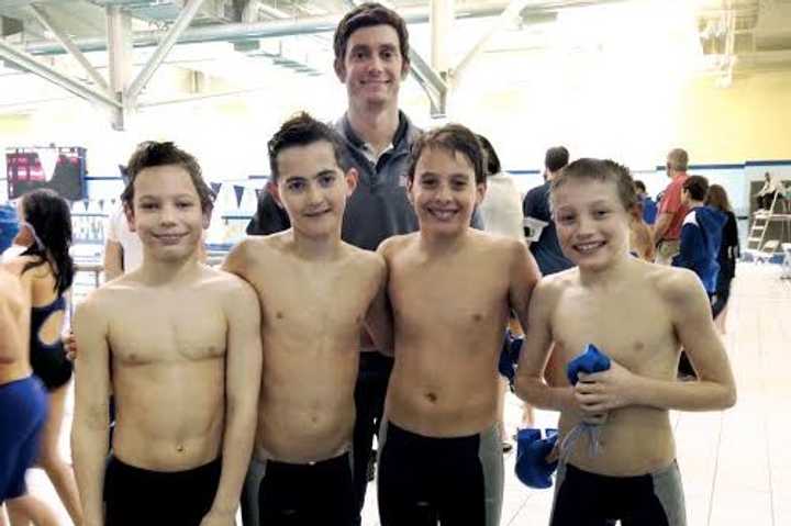 Chelsea Piers Connecticut swimmers (left to right) Tyler Sicignano, Gavin West, Alex Plavoukos and Nicholas Malchow join coach Greg Barone after setting the state record.