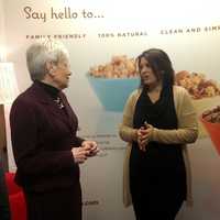 <p>Ola! Foods founder Dina Houser (center) speaks with Lt. Gov. Nancy Wyman and State Sen. Bob Duff at her Norwalk business Friday.</p>