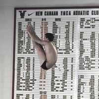 <p>Bobby Ross of New Canaan soars in the pike position.
</p>