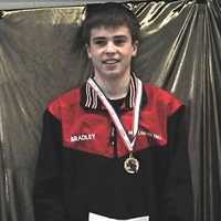 <p>Kevin Bradley of Norwalk smiles on the podium.</p>