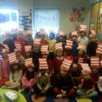 <p>The Cat in the Hat was read to them by their teacher who was also dressed liked him.</p>