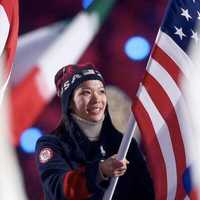 <p>Julie Chu of Fairfield carries the U.S. flag at the closing ceremony in Sochi in February. </p>