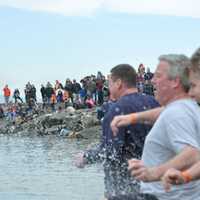 <p>People plunging into the cold Hudson River water last year. </p>