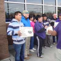 <p>Norwalk Common Council member David Watts leads protesters in a chant for an end to income inequality.</p>