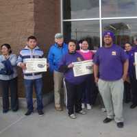 <p>Protesters gather and sign petitions outside the Walmart in Norwalk to show their support for three bills that they believe will help the middle class.</p>