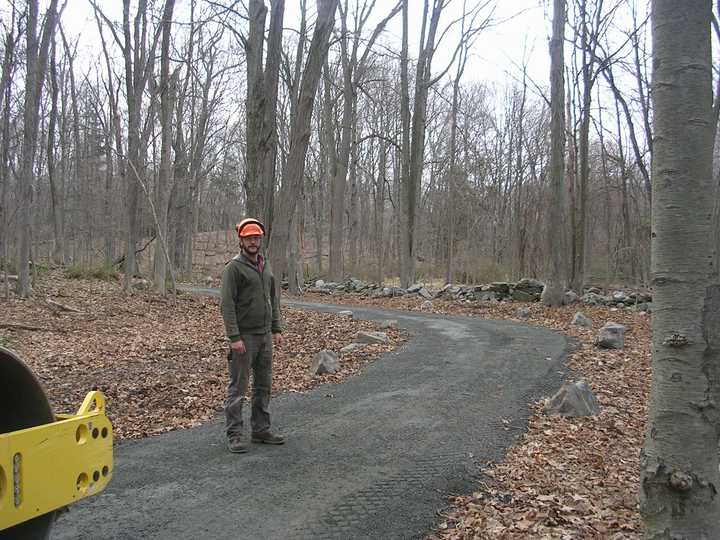 A worker stands on the Norwalk River Valley Trail in Wilton. A piece of the trail is finished and a ribbon cutting will be held on Saturday.