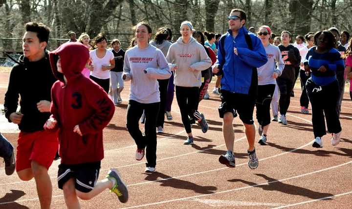 Sacred Heart University exercise science students hold a track clinic with children from local Bridgeport schools.