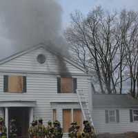 <p>Firefighters stand in front of a New Castle home used for training.</p>