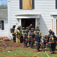 <p>Firefighters stand in front of a New Castle home used for training.</p>