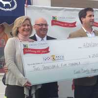 <p>Brooks Shopping Center representatives present Ellen Lynch with a check for $2,500.</p>