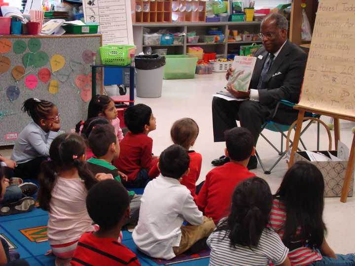 Dudley Williams of GE reads to kindergartners at KT Murphy Elementary School in Stamford.