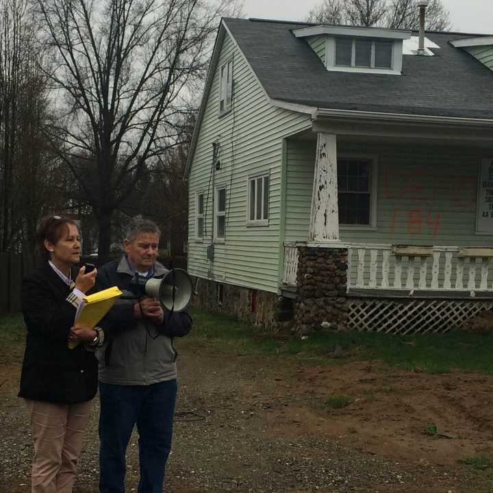 Fairfield resident Melanie Marks speaking with Ed Collins of Milford on April 16 about possibly finding information that could save the house for another 60 days.