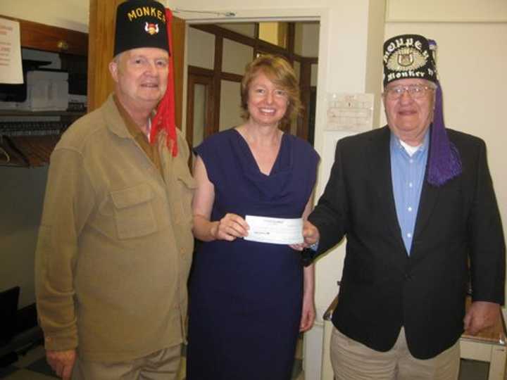 Mark Walker, Norwalk Senior Centers Executive Director Beatrice Winter and Norwalk Monker Grotto Chapter Secretary Danny Obuchowski display the check for the Norwalk Senior Center computer lab. 