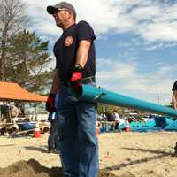 <p>Stamford firefighters, Capt. Jim Kelly, left, and Adam Fullilove, at right, help in playground building at West Beach Friday in honor of Jesse Lewis, one of the 20 students killed at Sandy Hook Elementary School.</p>