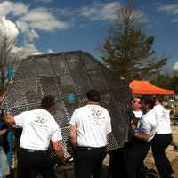<p>Volunteers help build a playground at West Beach Friday in honor of Jesse Lewis, one of the 20 students killed at Sandy Hook Elementary School.</p>
