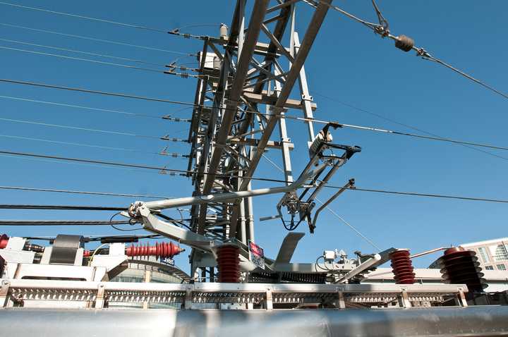 A new M-8 railcar is hooked up to the overhead catenary wires on the New Haven Line.