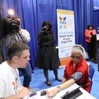 <p>Westchester County Executive Robert P. Astorino watches as volunteer technician João Pinto, a student at Pace University, takes the vital signs of Shirley Hunter, a resident of the Soundview Apartments at United Hebrew in New Rochelle.</p>