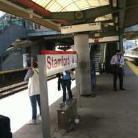 <p>Commuters wait for the 11:25 a.m. train to Grand Central Terminal on Monday in Stamford. A fire Saturday in Cos Cob damaged an important switching station, Metro-North officials said.</p>