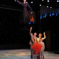 <p>Lauren Blackman as Mary Poppins goes airborne as Joe Dellger (as Mr. Banks), Leisa Mather (as Winifred Banks), Jane Shearin (as Jane Banks) and Gabriel Reis (as Michael Banks) and watch with admiration.</p>