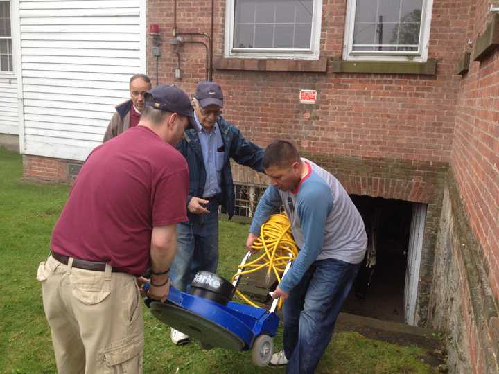 Volunteers from Norwalk&#x27;s Knights of Columbus help to clean out the basement of the Notre Dame Convalescent Home recently.