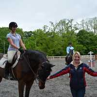 <p>Ashley Yozzo poses for a photo with horses at Summit Farm in North Salem.</p>