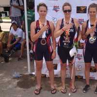 <p>Amy Dixon, second from left, stands at the medal ceremony with other members of Team USA.</p>