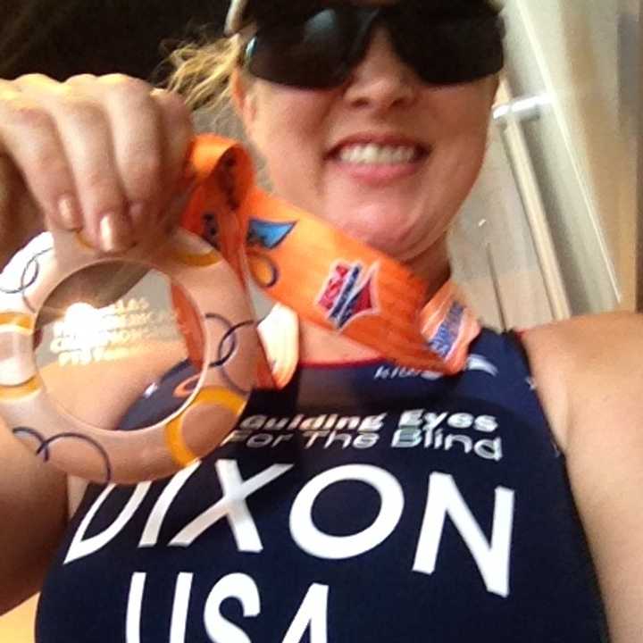 Amy Dixon proudly displays her bronze medal after finishing third Sunday in her division of the Pan American Triathlon Confederation paratriathlon championships.