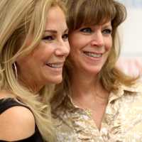 <p>Kathie Lee Gifford poses for a photo with a fan.</p>