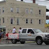 <p>The runner with the Special Olympics torch makes the turn from Main Street onto South Street near Rogers Park in Danbury on Friday morning. </p>