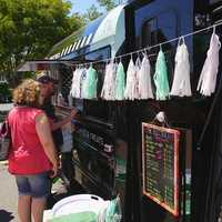 <p>People line up for coffee at the Buzz Truck, a new venture from Fairfield residents Jessica and Alex Grutkowski. </p>