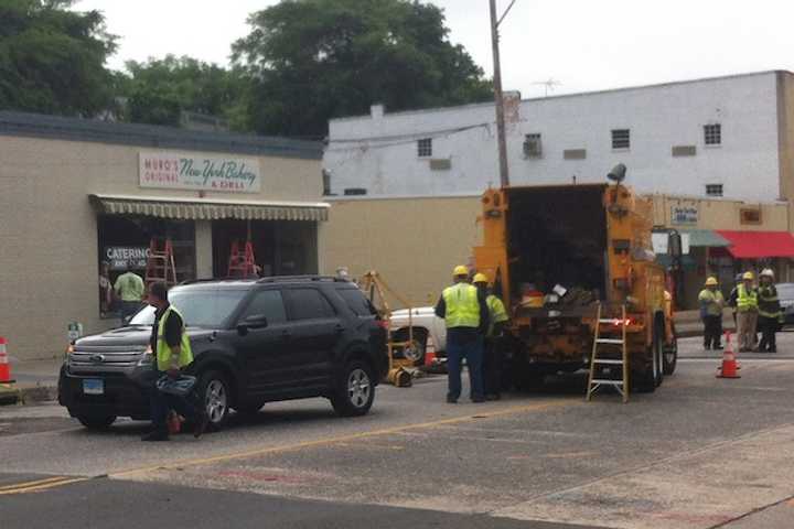 Emergency personnel work on the scene of an explosion on Main Street in Norwalk on Tuesday.