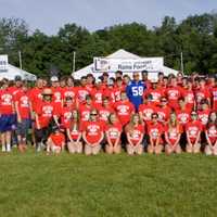 <p>The New Canaan football team with Mark Herzlich of the New York Giants.</p>