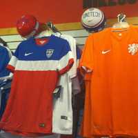 <p>Jerseys and soccer balls of World Cup nations on the wall at Soccer &amp; Rugby Imports at 42 W. Putnam Ave. The World Cup begins Thursday in Brazil.</p>