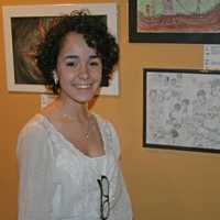 <p>Taina Pagan, 17, a student at The Center for Global Studies in Norwalk, stands by her entry, A Family Gathering, at the reception for the 18th International Childrens Art Show.</p>