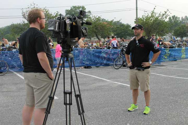 Jon Stellwagen, race director of the Navigators KIC It Triathlon in Stamford, does an interview at last year&#x27;s race. 