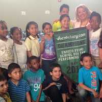 <p>Enrico Fermi principal Miriam Digneo proudly displays her school&#x27;s new banner with some of her students.</p>