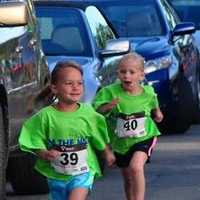 <p>Young runners head for the finish line at the New Canaan Mile.</p>