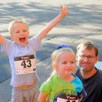 <p>A family of runners celebrates at the finish.</p>