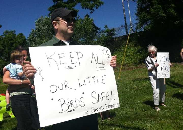 Fairfield residents hold a protest Saturday as they seek to have sound barriers built at the I-95 northbound rest area. Kurt Potter holds a sign saying barriers would help protect the nearby bird sanctuary.