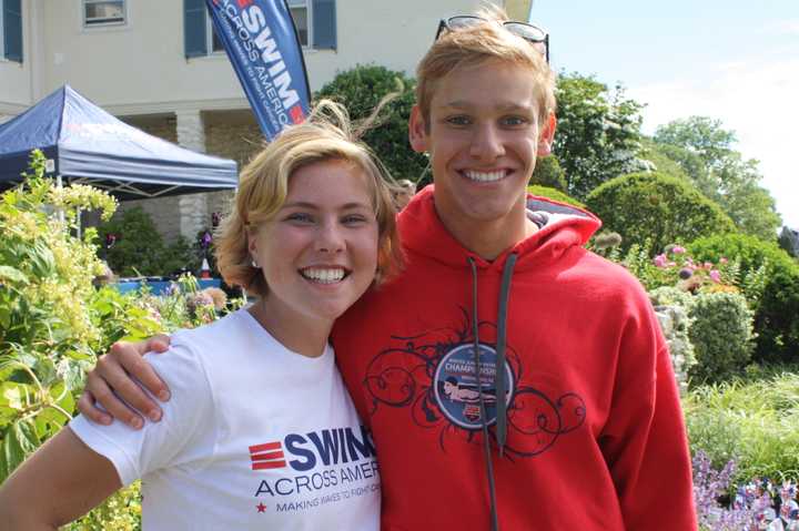 Greenwich High School seniors and Alliance for Cancer Gene Therapy (ACGT) interns Nicole Graham, left, and Alex Lewis meet at Swim Across America. Graham is a cancer survivor.
 