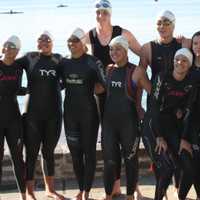 <p>A team takes a photo before Swim Across America.</p>